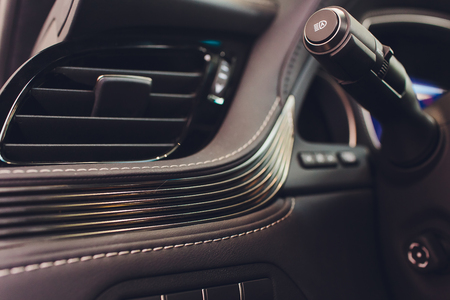Dark luxury car Interior - steering wheel, shift lever and dashboardの写真素材