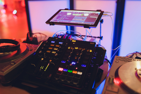 DJ hands on the remote. nightclub. DJ controlling and moving the mixers in music remoteの写真素材