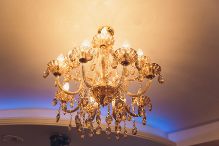 Chrystal chandelier lamp on the ceiling in Dining room Adjusting the image in a Luxury tone .Decorative elegant vintage and Contemporary interior Concept.の写真素材
