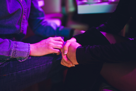 Happy love couple holding hands in a restaurant.の写真素材