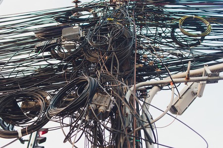 Crazy messy chaos wires cables on Electric poles.の写真素材