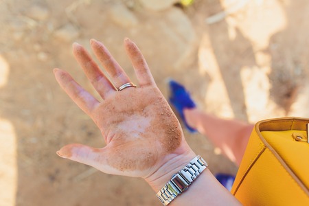 wipes dirty baby hands with a wet napkin. The concept of cleanliness and hygiene.の写真素材