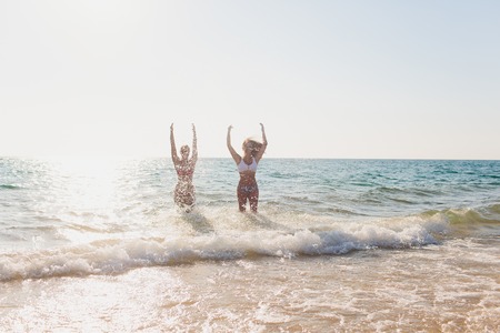 The girl is coming out of the ocean.の写真素材