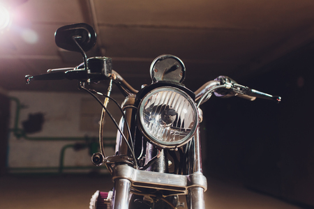 motorcycles on the floor with workshop tools, a modern garage, storage and repair. This bike will be perfect. repairing a motorcycle in a repair shop.の写真素材