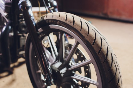 motorcycles on the floor with workshop tools, a modern garage, storage and repair. This bike will be perfect. repairing a motorcycle in a repair shop.の写真素材