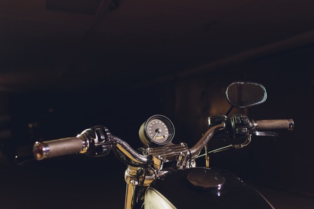 motorcycles on the floor with workshop tools, a modern garage, storage and repair. This bike will be perfect. repairing a motorcycle in a repair shop. speedometer close upの写真素材