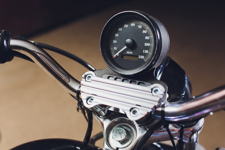 motorcycles on the floor with workshop tools, a modern garage, storage and repair. This bike will be perfect. repairing a motorcycle in a repair shop. speedometer close upの写真素材
