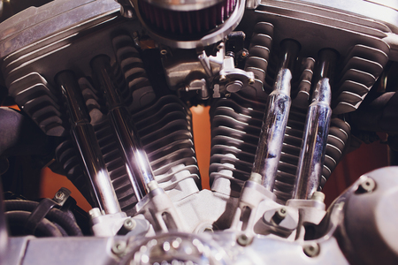 Motorcycle engine, metallic background with exhaust pipes.
