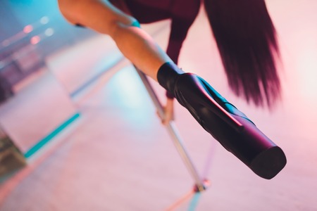 young striptease dancer moving in high heels shoes on stage in strip night club, Pole dancing.