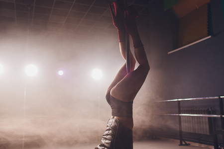 young striptease dancer moving in high heels shoes on stage in strip night club, Pole dancing.の写真素材