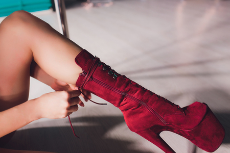 young striptease dancer moving in high heels shoes on stage in strip night club, Pole dancingの写真素材