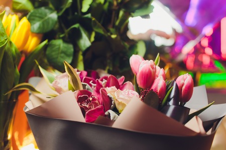 Close up of a beautiful bouquet of roses in soft colors. Bockeh background, restaurant in deaf....
