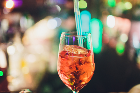 glasses of cocktails on the bar. bartender pours a glass of sparkling wine with Aperolの写真素材