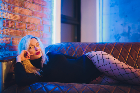 beautiful young woman.fashion art photo of elegant model in the light colored spotlights.の写真素材