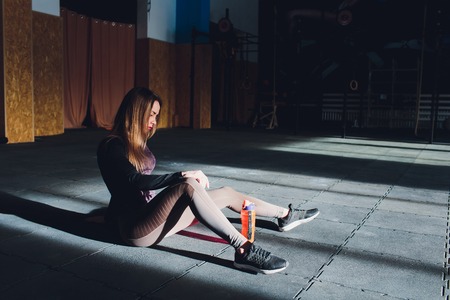 Beautiful young woman in fitness center doing pilates exercise with fitness ball. Healthy lifestyle concept.の写真素材