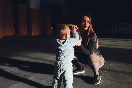 Woman as a therapist at physiotherapy and sports with child in gym.の写真素材