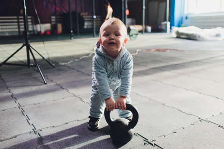 Healthy lifestyle child exercising dumbbell weight sport.の写真素材
