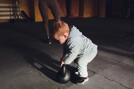 Healthy lifestyle child exercising dumbbell weight sport.の写真素材