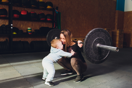Woman as a therapist at physiotherapy and sports with child in gym.の写真素材
