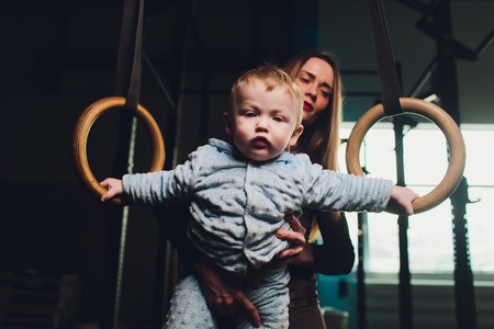Woman as a therapist at physiotherapy and sports with child in gym.の写真素材