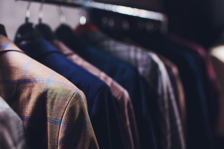 workpiece jackets on clothes hanger in tailoring studio.の写真素材