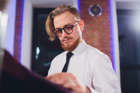 Young shopaholic man chousing jacket at boutique.