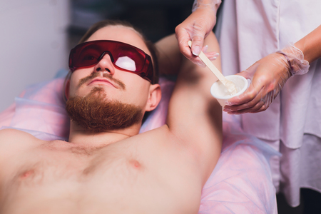 Male depilation laser hair removal procedure treatment. Skin preparation process of preparing, applying gel.の写真素材