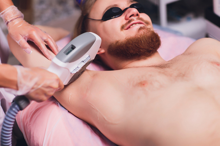 Young Woman Having Underarm Laser Hair Removal Treatment In Beauty Spa Clinic.の写真素材