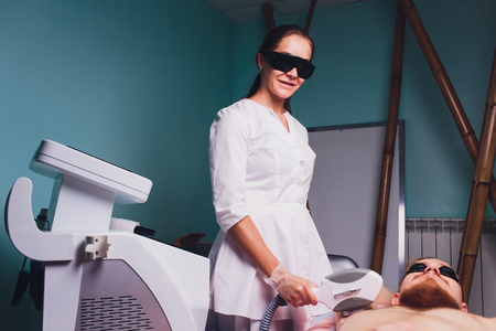 Male depilation laser hair removal procedure treatment. Skin preparation process of preparing, applying gel.の写真素材