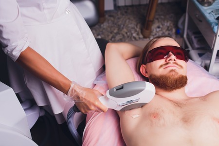 Young Woman Having Underarm Laser Hair Removal Treatment In Beauty Spa Clinic.の写真素材