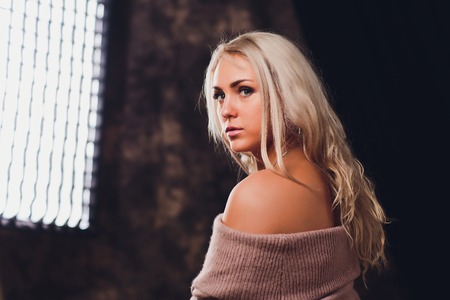 Beautiful woman with long straight blond hair. Fashion model posing at studio.の写真素材