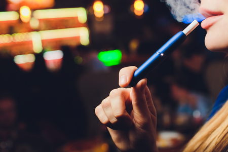 New design. Showcase with a large multi-colored selection System of heating of tobacco. Color devices for smoking. New technology of electronic cigarettes. heating of tobacco.の写真素材