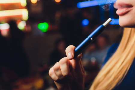 New design. Showcase with a large multi-colored selection System of heating of tobacco. Color devices for smoking. New technology of electronic cigarettes. heating of tobacco.の写真素材