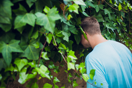 the man got into the bushes with his head.の写真素材