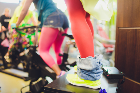 Beautiful young woman in a gym female on bicycle. fannyの写真素材