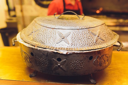 Raw meat grill on the skewer is placed in a special oven - tandoor for cooking. Street food.の写真素材