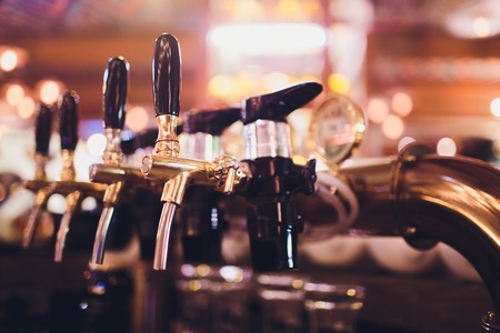 beer tap pours draught lager beer serving in a restaurant or pub.