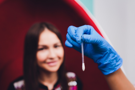 Portrait of young woman visiting dentist office for teeth whitening with photopolymer.の写真素材