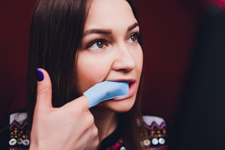 Portrait of young woman visiting dentist office for teeth whitening with photopolymer.の写真素材