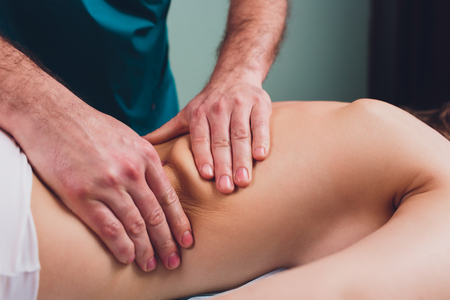 Young beautiful woman having massage in spa salon Physiotherapisの写真素材