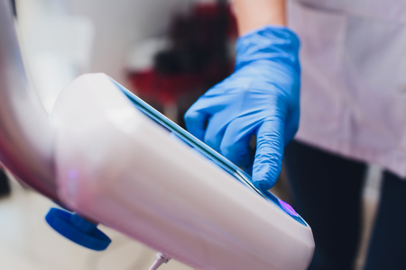 Dentist curing female patient Woman teeth examined at dentists teeth whitening. stomatology office Tooth care and tooth health. dentist working at her patients teeth.Teeth whitening procedure,choiceの写真素材