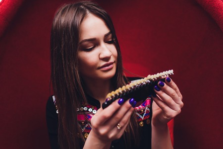 Dentist curing female patient Woman teeth examined at dentists teeth whitening. stomatology office Tooth care and tooth health. dentist working at her patients teeth.Teeth whitening procedure,choice.の写真素材