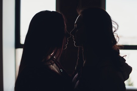 LGBT lesbian women couple moments happiness. Lesbian women couple together outdoors concept. Lesbian couple embraced together relation fall in love.の写真素材