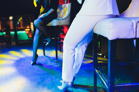 The female student is holding the black wireless microphone in the left hand and do the public speaking with blurred background.の写真素材