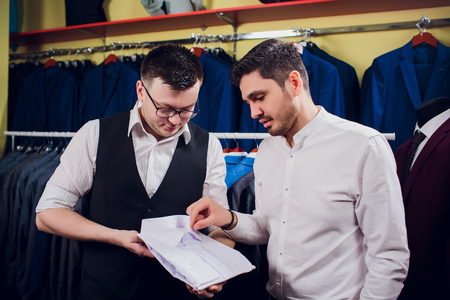 man is buying shirt in storeの写真素材