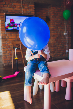 The small girl seen through a transparent balloon.の写真素材