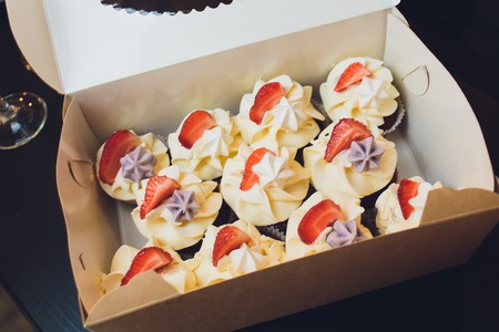 cupcakes in a white box, delivery of cupcakes, cupcakes with fresh red currant, close-up photo of cupcakes.の写真素材