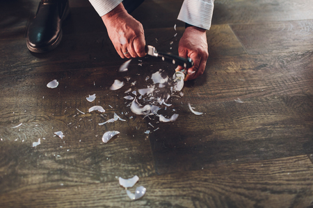 Broken bulb on the wooden floor with copy space view from top