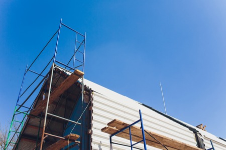 Scaffold between floors and interior partitions in construction building aerial view. Employees working on construction site of high rise buildingの写真素材