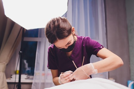 Hair removal. Mans face sugaring epilationsy ellow color, in cosmetology on the couch. hair removal inside the nose.の写真素材